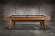 Side profile view of the Doc & Holliday Scholar Pool Table | Heritage Maple finish on solid maple hardwood with streamlined mid-century modern silhouette and tapered legs | Premium slate pool table handcrafted in the USA for contemporary living spaces Side profile view of the Doc & Holliday Scholar Pool Table | Heritage Maple finish on solid maple hardwood with streamlined mid-century modern silhouette and tapered legs | Premium slate pool table handcrafted in the USA for contemporary living spaces